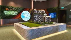 Architectural model of Lentoria apartment blocks displayed on a marble table with green backdrop and map panel