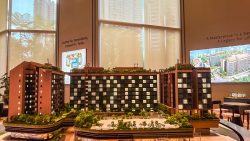 Architectural scale model of The Robertson Opus development with greenery on rooftop terraces and surrounding trees