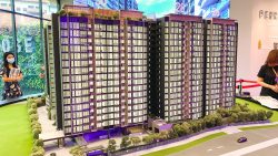 Penrose residential blocks model with labelled child care centre, guard house, and greenery in sales gallery