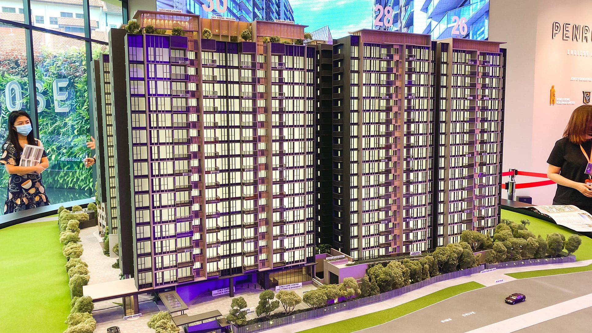 Penrose residential blocks model with labelled child care centre, guard house, and greenery in sales gallery