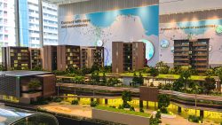 Pasir Ris 8 scale model with residential blocks, greenery, a clubhouse, and illuminated sales gallery interior