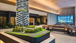 Architectural model of high-rise residential building with greenery inside sales gallery lounge area