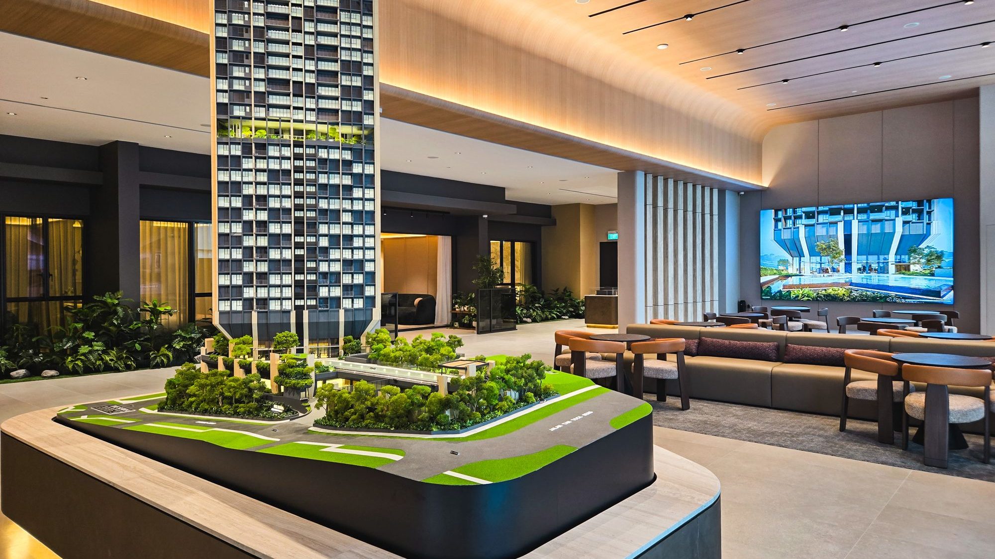 Architectural model of high-rise residential building with greenery inside sales gallery lounge area
