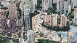 Construction site outlined in white among multiple high-rise residential and commercial buildings