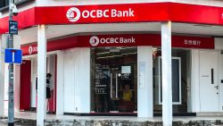 OCBC Bank branch with red signage and an ATM booth on the street corner