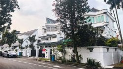 Two white semi-detached houses with grey tiled roofs on a tree-lined street corner with parked cars