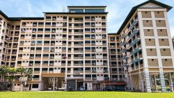 Tanjong Pagar HDB flat block with multiple stairwells, grass foreground and clothes hanging outside windows