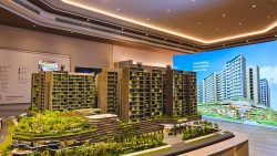 Architectural model of residential apartment blocks with green terraces and a shopping mall podium
