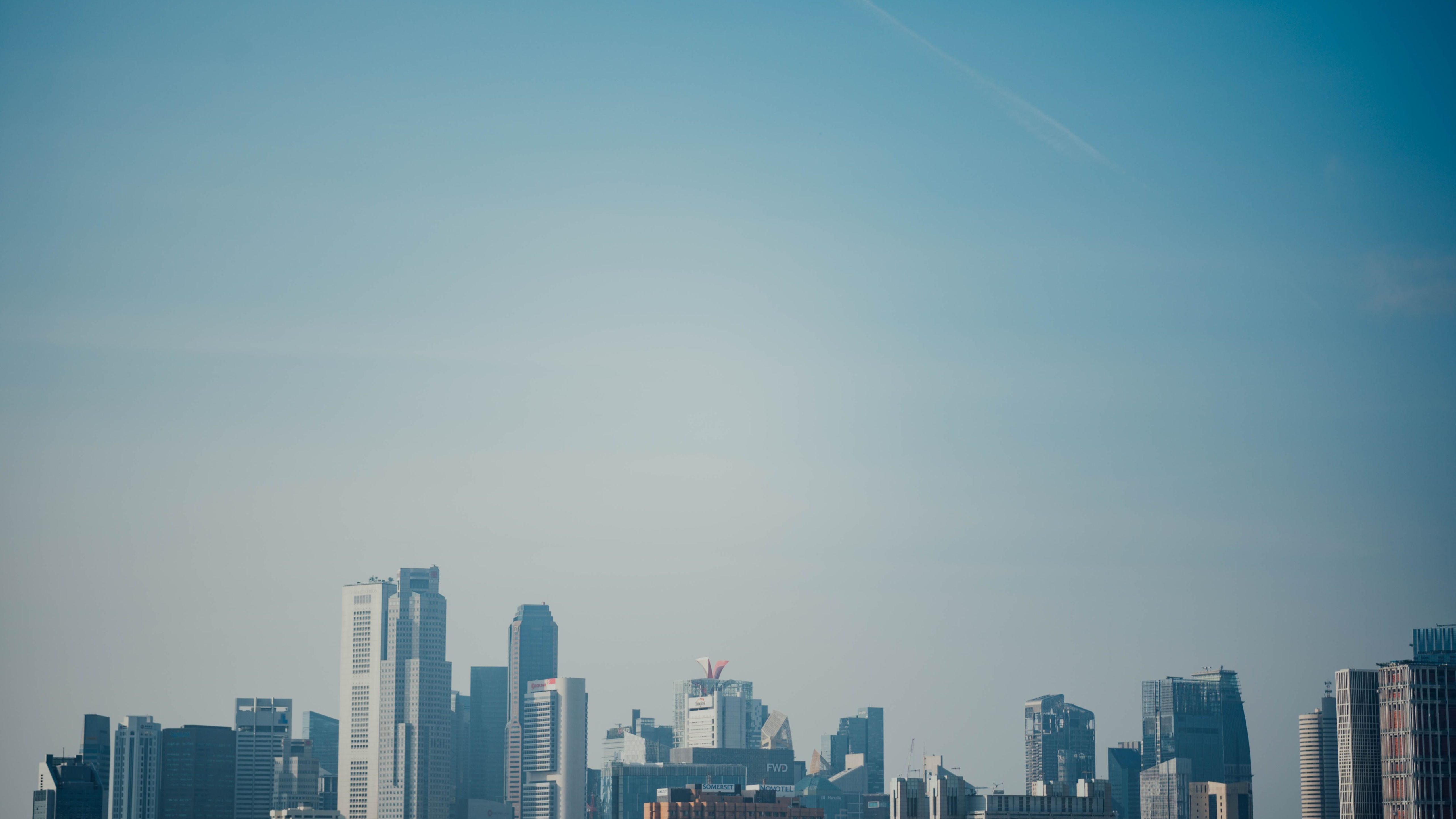 Cluster of high-rise commercial buildings and offices beneath a clear blue sky in a city skyline