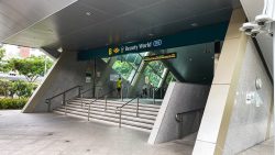 Entrance B to Beauty World MRT station with stairs, handrails and surveillance cameras visible