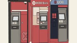 Three bank ATM machines side by side for OCBC Bank and UOB with red and blue panels