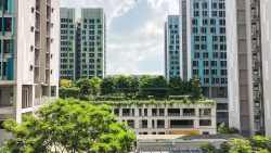 Alkaff Oasis apartment blocks with green rooftop garden and trees under a partly cloudy sky
