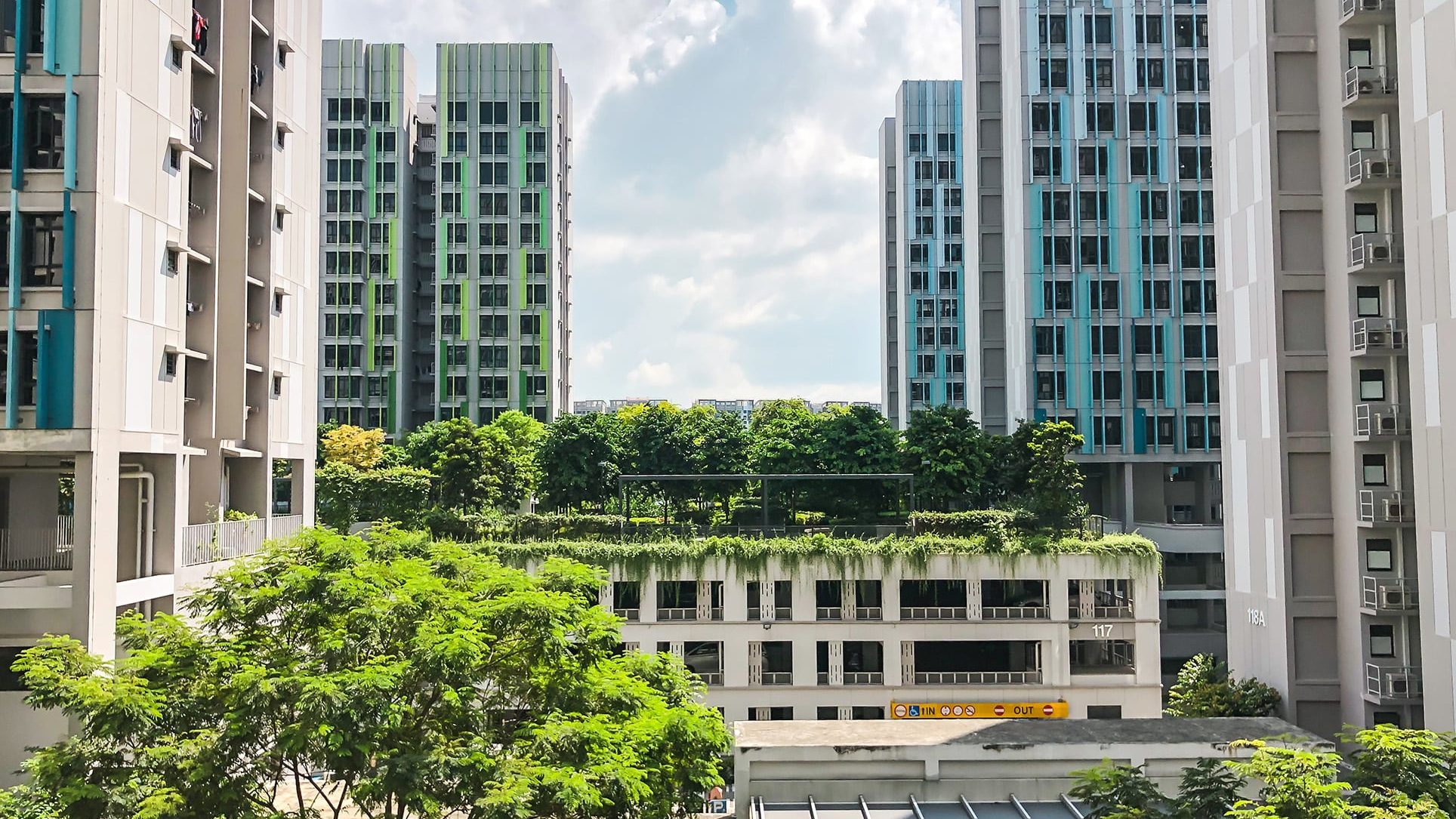 Alkaff Oasis apartment blocks with green rooftop garden and trees under a partly cloudy sky