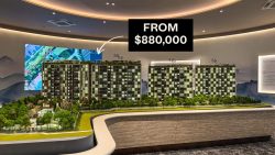 Scale model of residential apartment blocks surrounded by trees with price tag from $880,000 above
