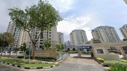 Aquarius at the Park residential blocks with gated entrance, guardhouse and trees along the road front