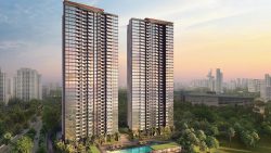 Two tall residential apartment blocks next to a swimming pool and greenery at dusk with city skyline background