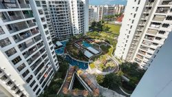 High-rise Adora Green DBSS blocks surrounding a landscaped playground with garden and seating areas