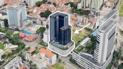 High-rise commercial building highlighted in a densely built urban area with surrounding low-rise housing blocks