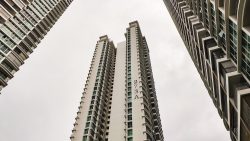 High-rise apartment blocks with balconies and windows under a cloudy sky, building number 273A visible