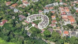 Curved apartment blocks highlighted with an arrow surrounded by trees and detached houses with tiled roofs