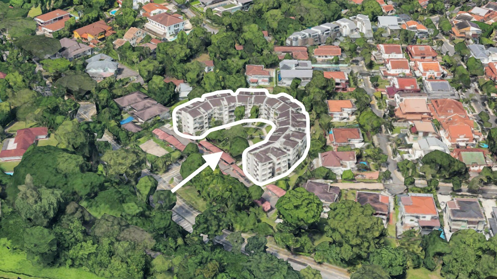 Curved apartment blocks highlighted with an arrow surrounded by trees and detached houses with tiled roofs