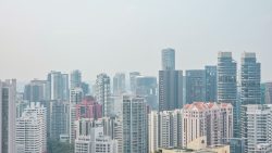 High-rise residential and commercial buildings forming a cityscape under a pale sky