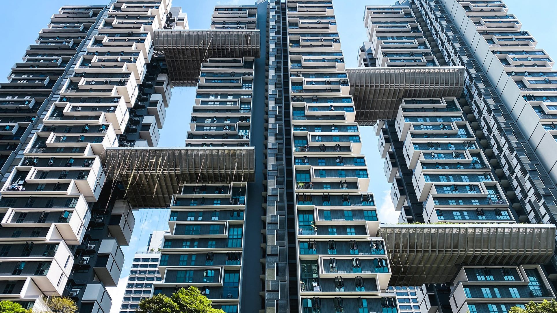 SkyTerrace@Dawson apartment blocks with sky bridges and blue-tinted windows against a clear sky