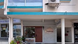Shophouse front with Thinktank sign, wooden door, plants, and Binjai Medical Clinic next door